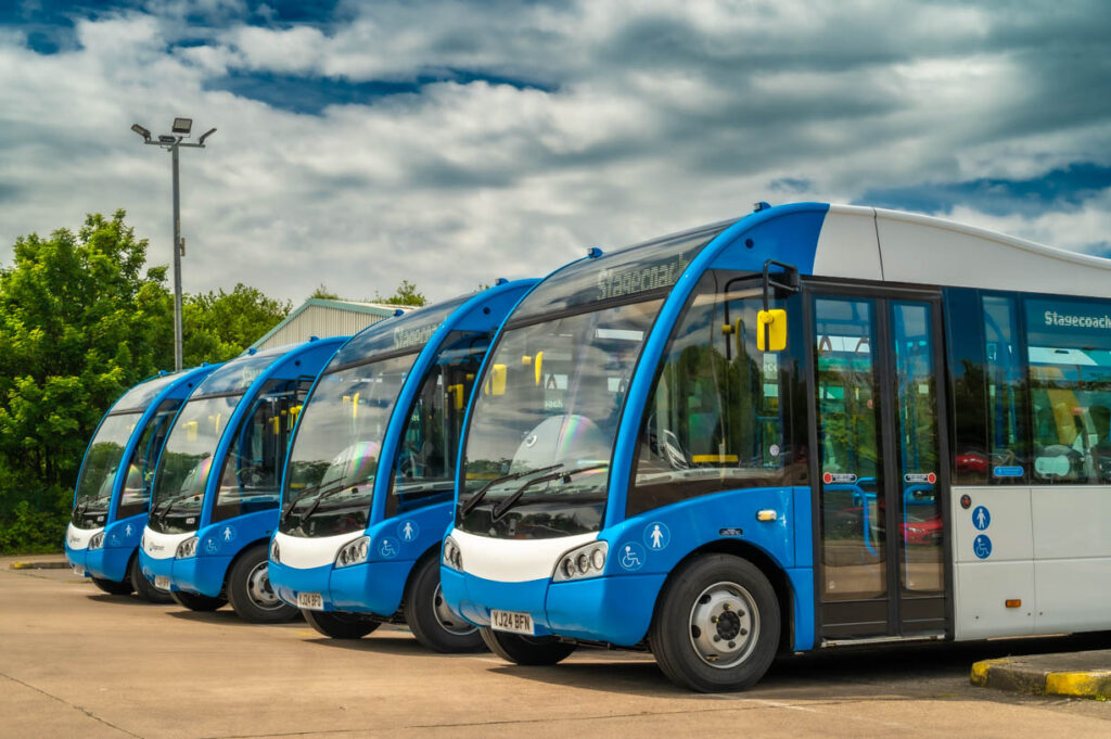 An image of three blue stagecoach buses lined up